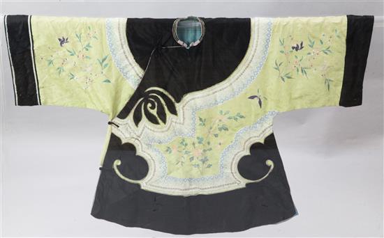 A Chinese yellow silk damask and black satin robe, late 19th century, length 83cm, removable perspex case